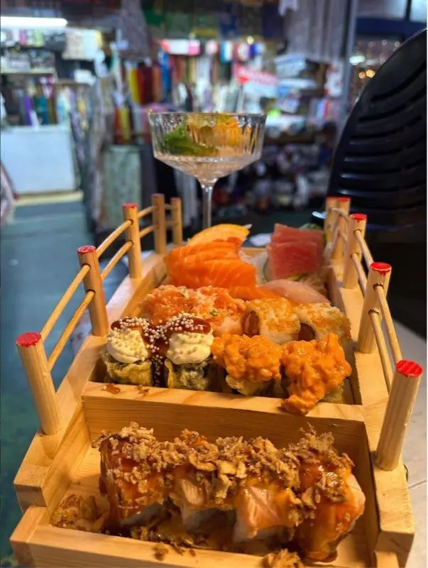 Sushi boat with sashimi, dragon rolls and nigiri